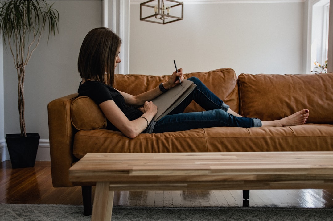 Woman at home reading and journaling with Reclaim